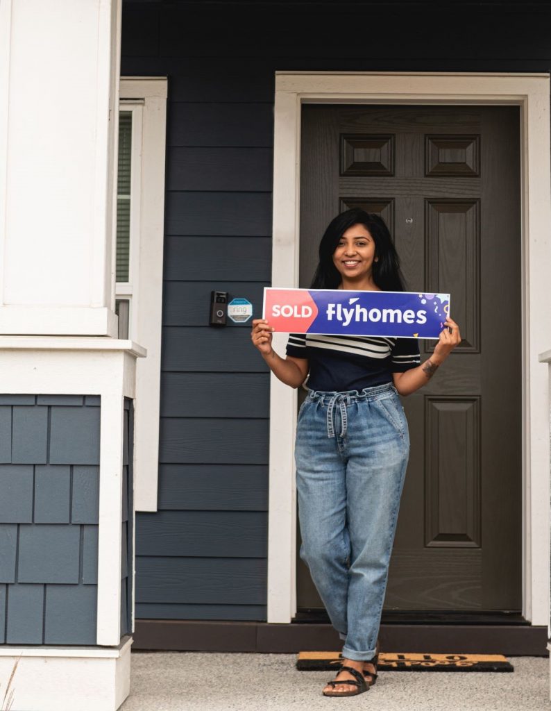 Flyhomes client with sold sign